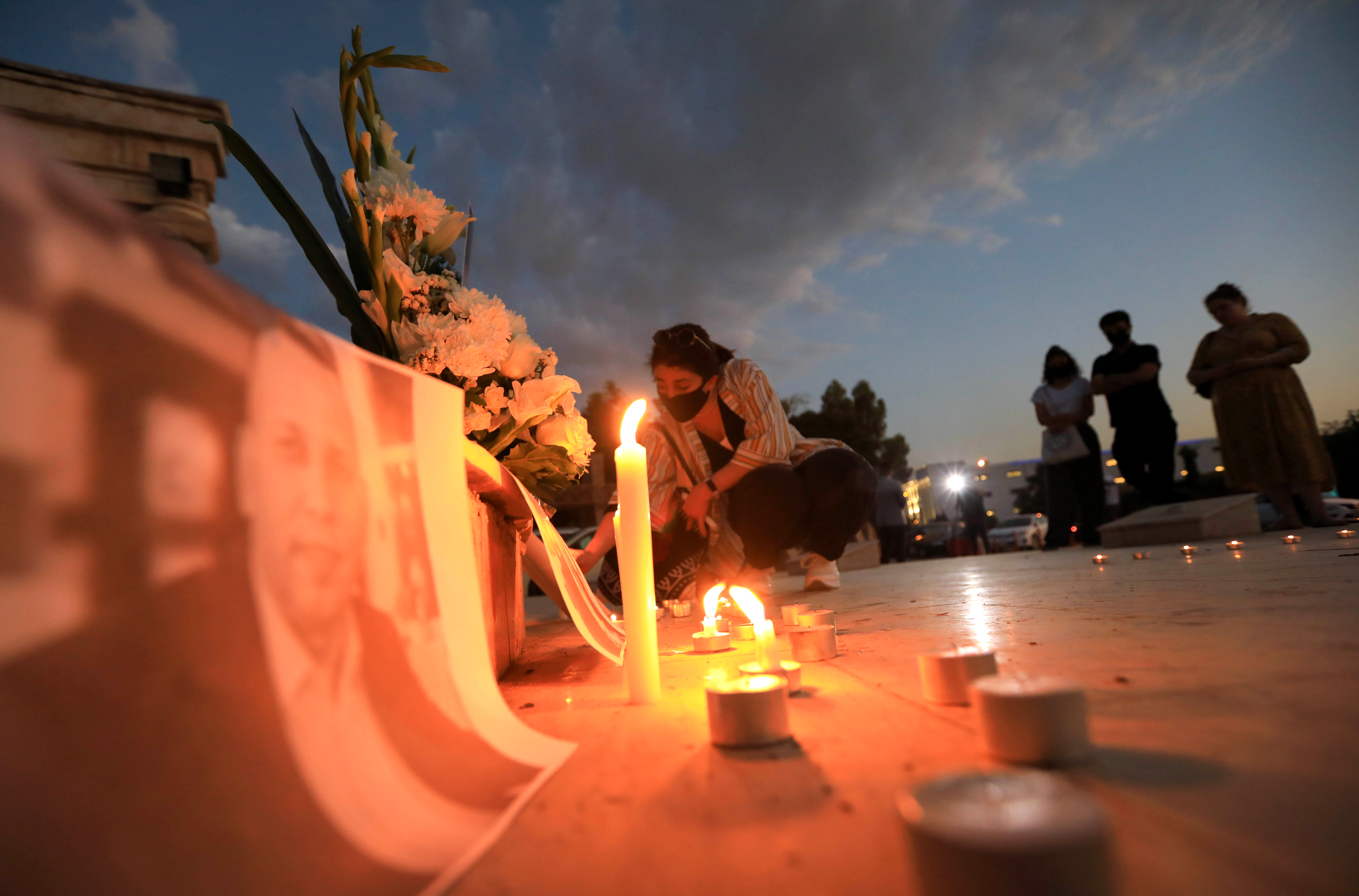 During the evening in Erbil city, a lady lights a candle to honor the death of Hisham al-Hashimi, July 11, 2020. (Photo: AFP/Safin Hamed)